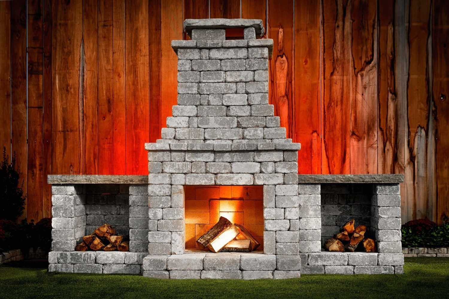Outdoor fireplace with a fire burning, built in a backyard